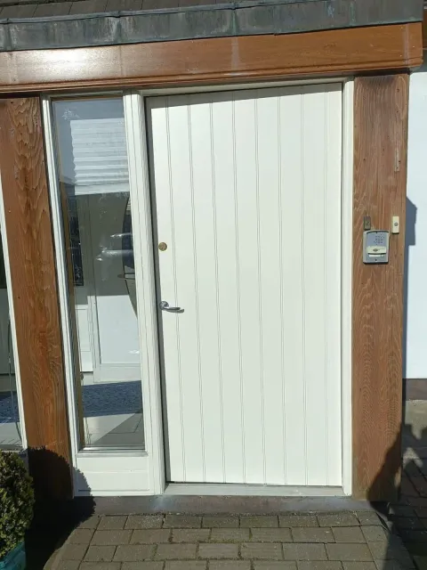 Front door repainted in clean cream