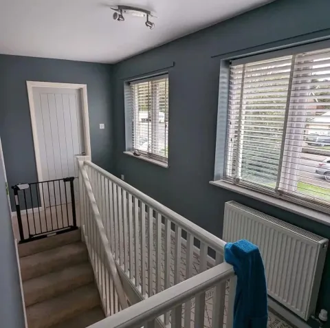 Upstairs landing painted in slate blue with white trim