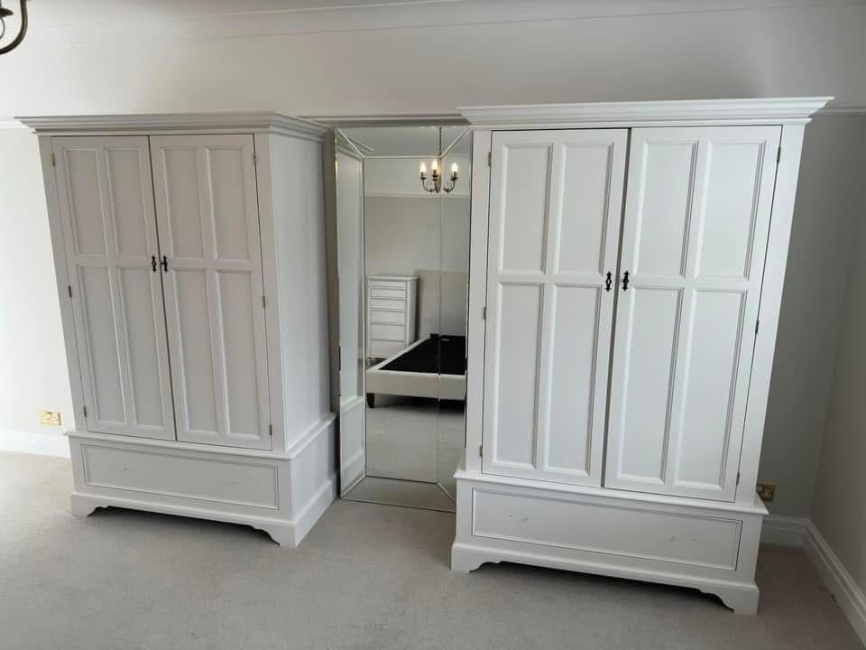 Hand-painted white wardrobes in a bedroom