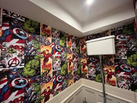 Downstairs WC hung with Marvel Avengers wallpaper