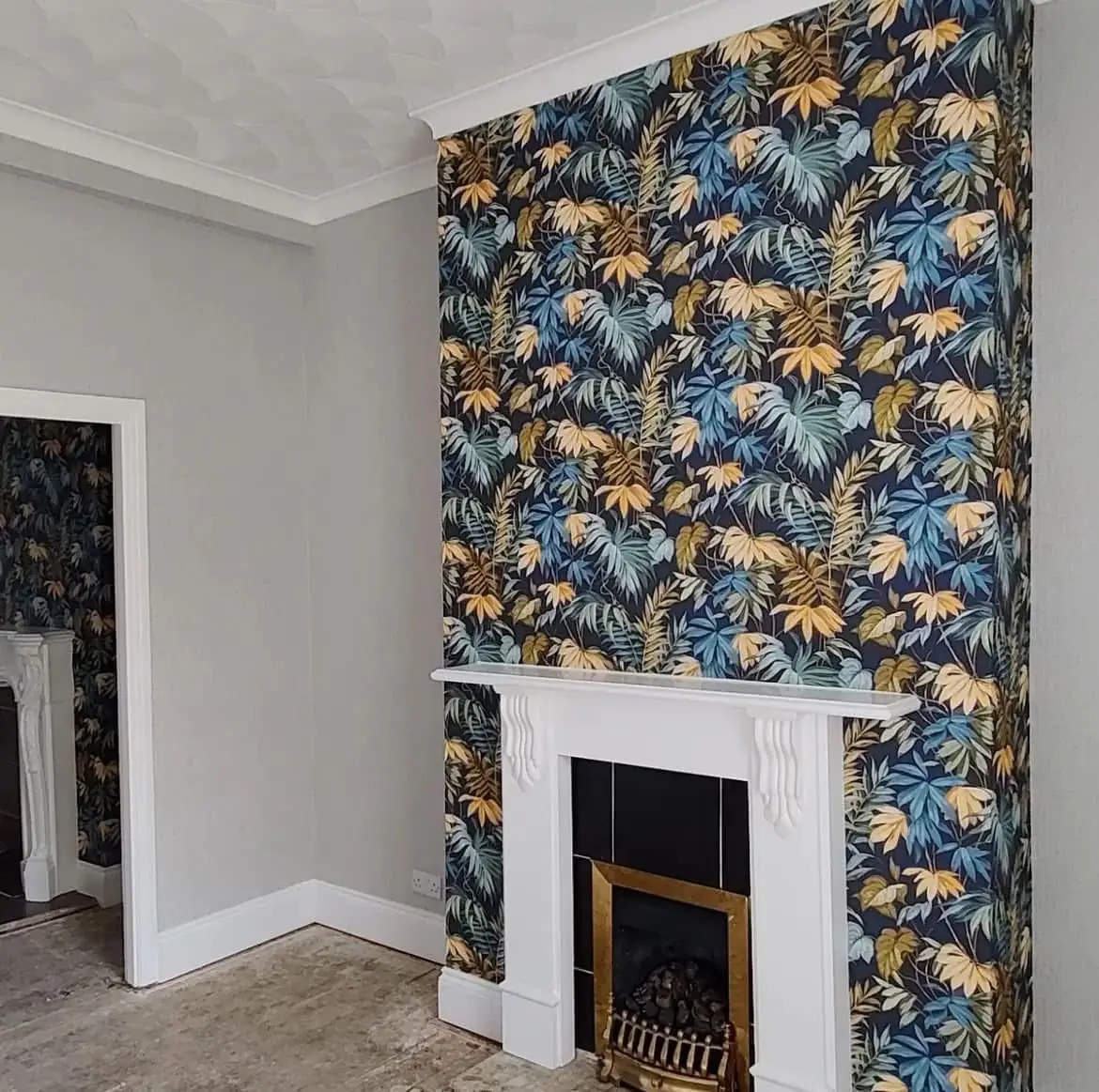 Tropical leaf wallpaper on a chimney breast in a Dublin living room